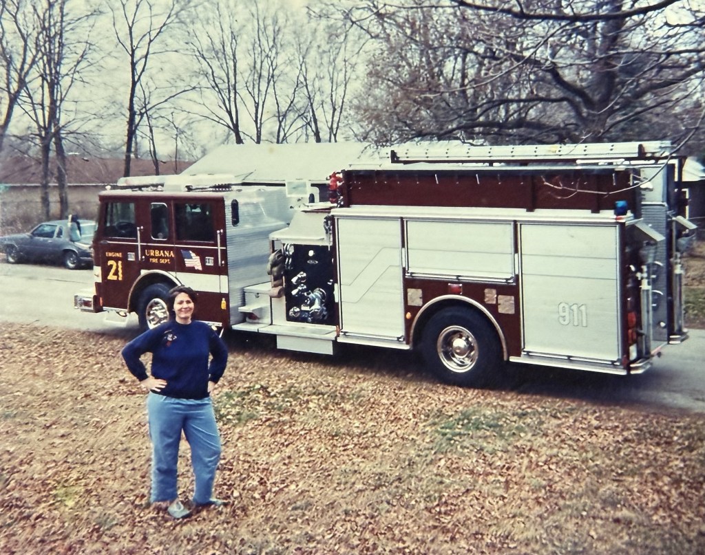 A woman in front of an Urbana fire engine.