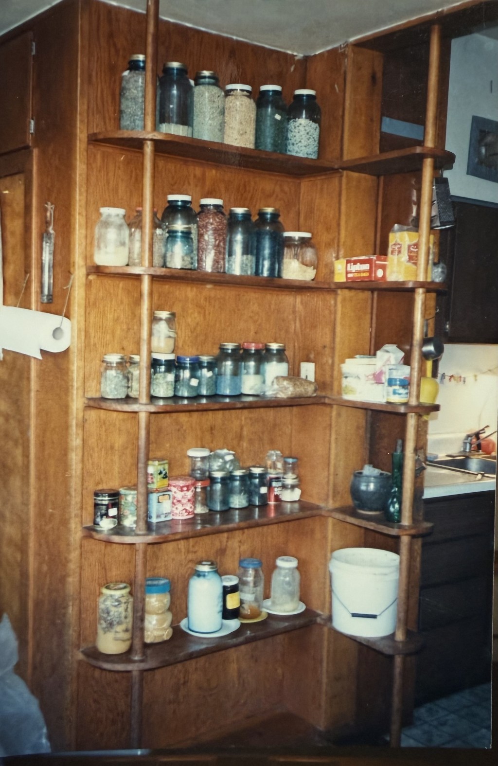 Corner shelves stacked with home-canned jars.