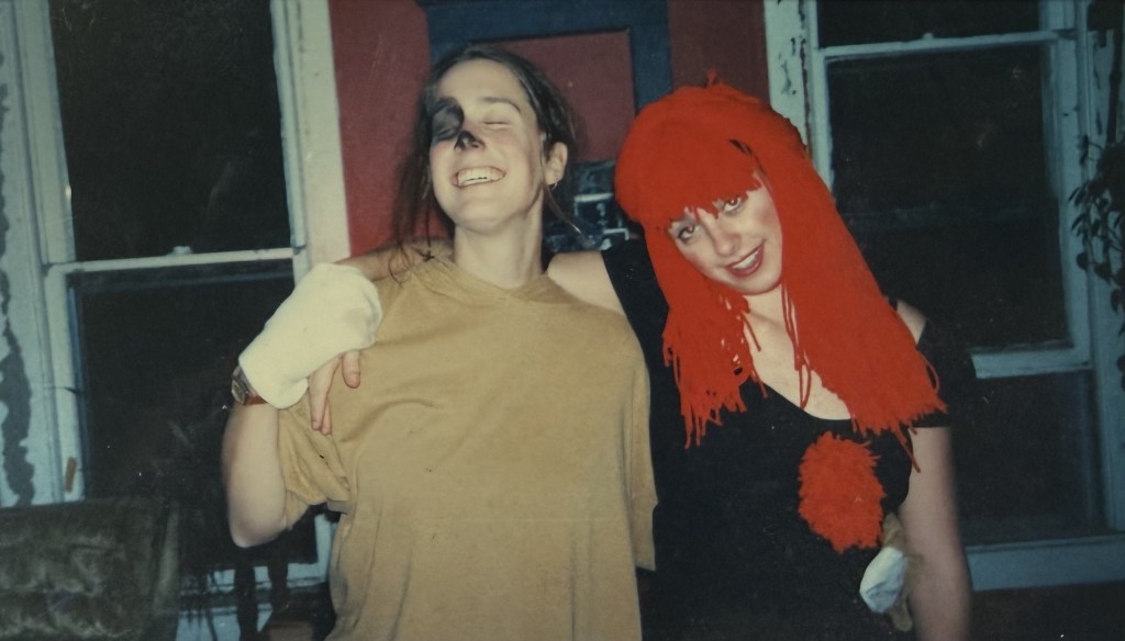 Two people in Halloween costume on the porch.