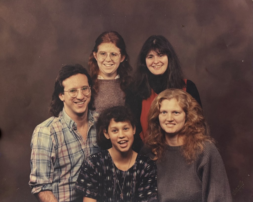 Posed group portrait of five people.
